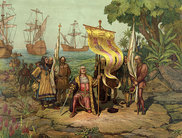 An oil painting: Christopher Columbus kneels on a rocky shore holding a flag, in the background is the sea with several ships.